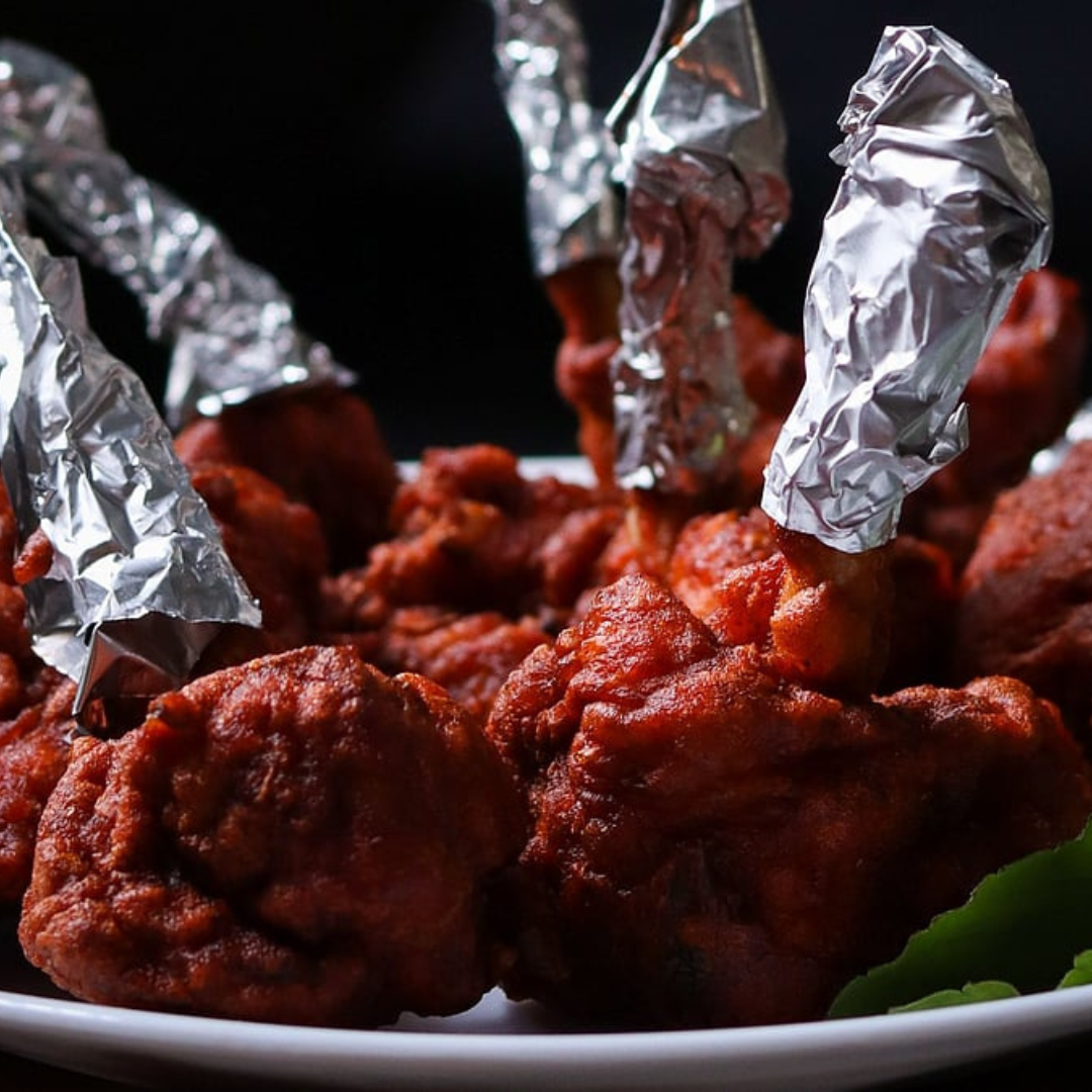 Eateries across Mumbai and Maharashtra are dropping bright artificial red and pink dyes from popular street foods like chicken lollipops, Manchurian, and cotton candy. This shift follows intensified surprise inspections and strict enforcement by the Maharashtra Food and Drug Administration (FDA) targeting unpermitted chemical additives and poor kitchen hygiene.